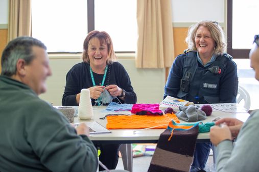 Volunteers crocheting with people in prison