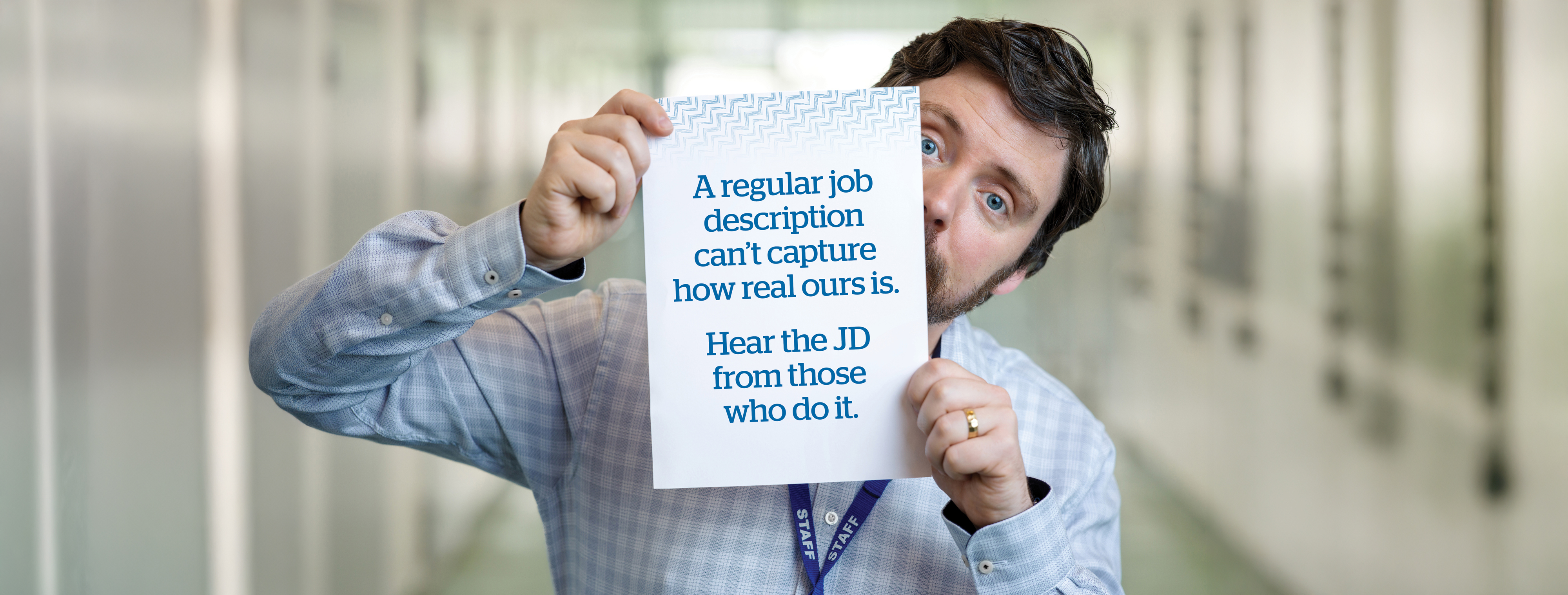 Guy the new recruiter holding a sign